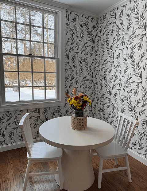 Dining nook with patterned wallpaper