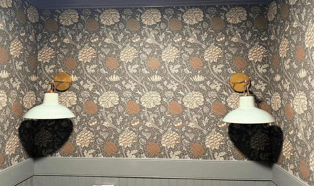 Dark floral wallpaper with wall sconces